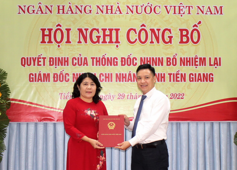Mr. Nguyen Anh Tuan, Deputy Director General of the SBV Organization and Personnel Department, handed over the Re-appointment Decision to Ms. Nguyen Thi Dam, Director of the SBV - Tien Giang provincial branch.