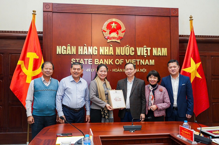 Phó Thống đốc Thường trực NHNN Đào Minh Tú trao tặng món quà kỷ niệm là cuốn sách Lịch sử Đồng tiền Việt Nam tới Đoàn công tác